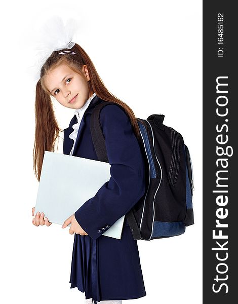 Little girl with backpack and book