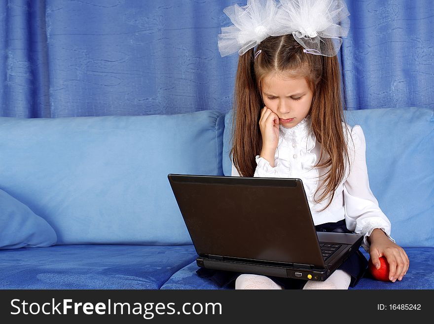 Girl with laptop and red apple