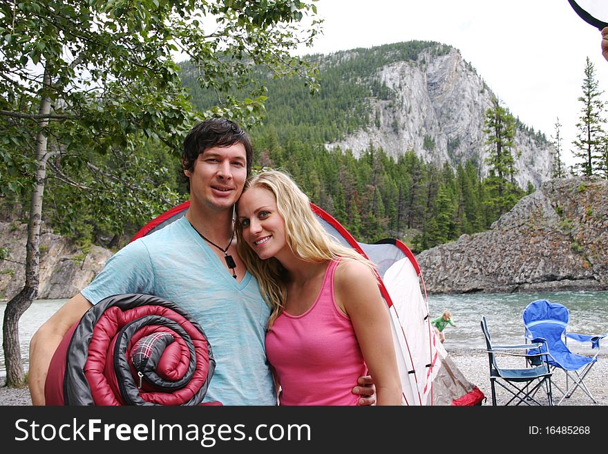 Couple enjoying a hug when tenting. Couple enjoying a hug when tenting