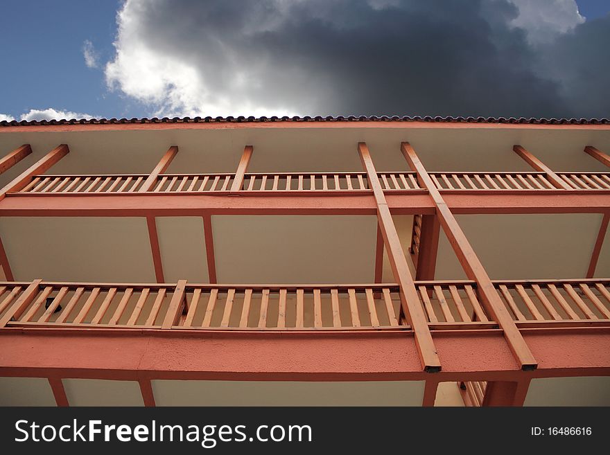 Two wooden balconies agaist dark cloud. Two wooden balconies agaist dark cloud.