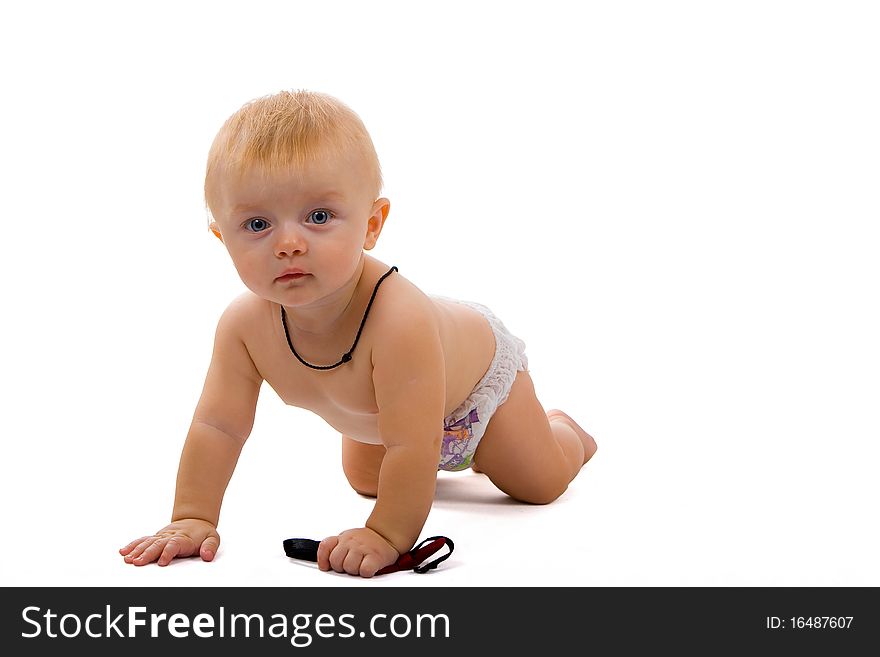 Boy at the age of eight months is grabbling on white background