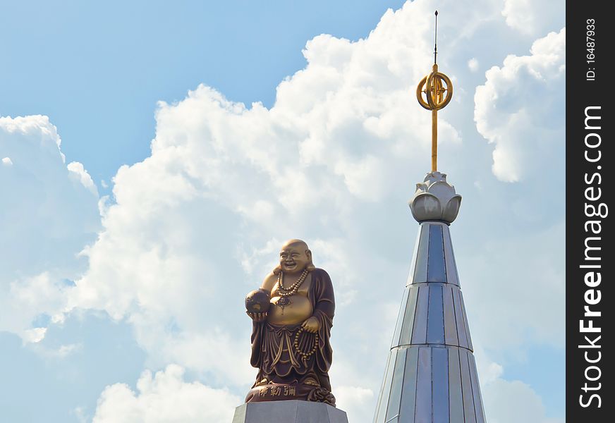 Golden statue and beautiful sky in afternoon