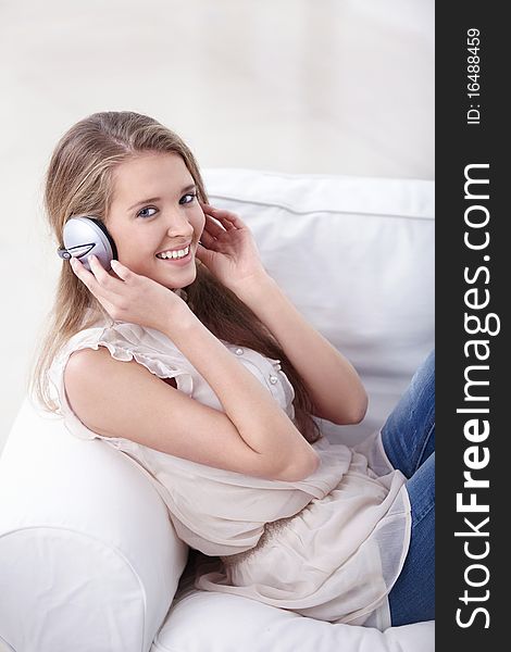 Beautiful girl listening to music on headphones. Beautiful girl listening to music on headphones