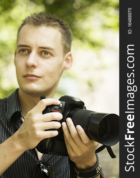 Young photographer in the park with camera