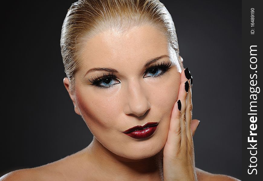 Fall fashion makeup and manicure trend. pretty woman face with perfect lips and black nails