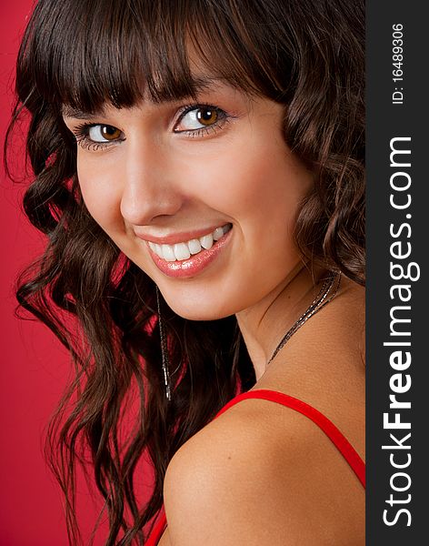 Portrait of beautiful young woman over red background