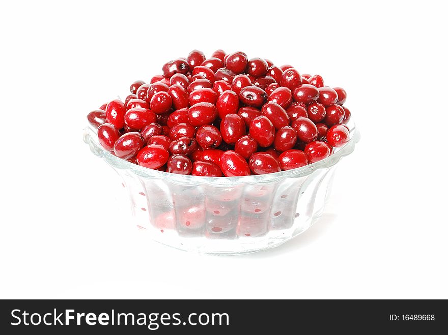 Dogwood berries on a plate on a white background, red berries, dishes, still life, full plate, rich color.