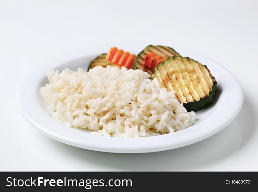 Grilled zucchini and white rice on a plate. Grilled zucchini and white rice on a plate
