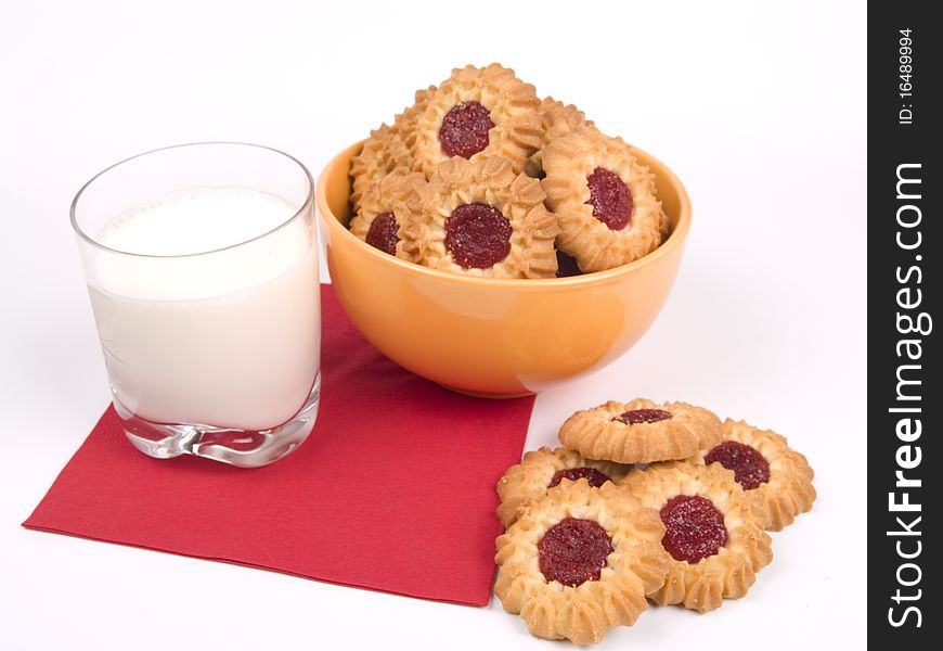 Bowl of fresh baked cookies with glass of milk. Bowl of fresh baked cookies with glass of milk