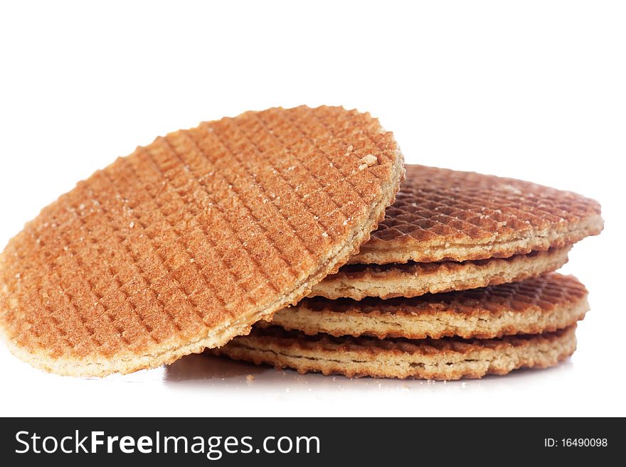 A stack of golden round waffles isolated over white background.