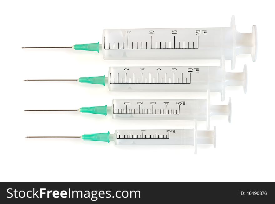 Four disposable syringe against white background