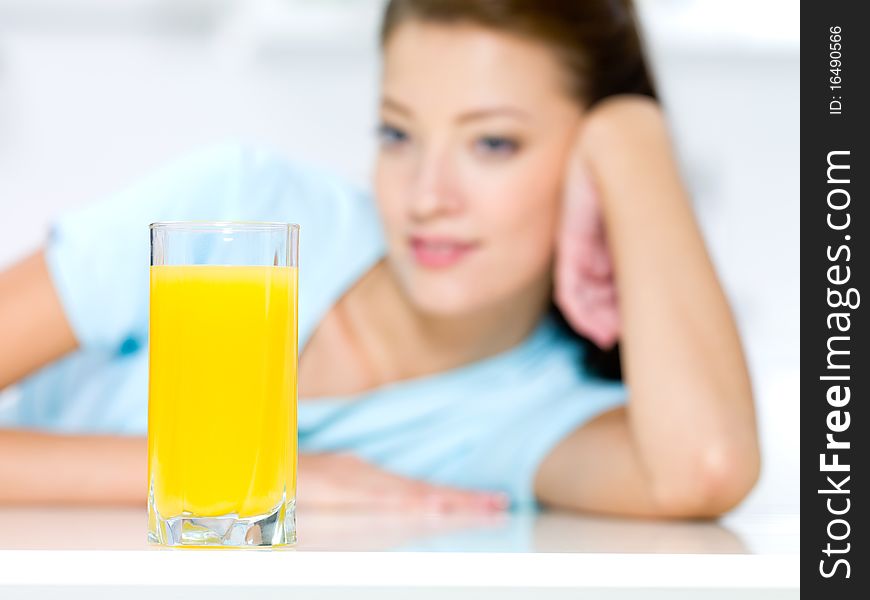 Girl with a glass of fresh orange juice