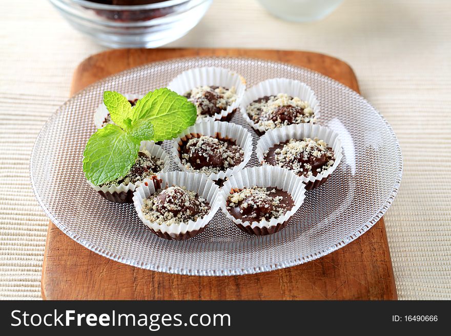 Chocolate in paper cups sprinkled with ground nuts. Chocolate in paper cups sprinkled with ground nuts