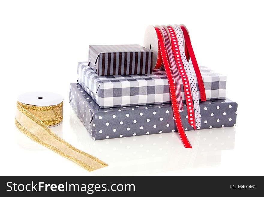 Gifts ribbons and wrappingpaper isolated on white background