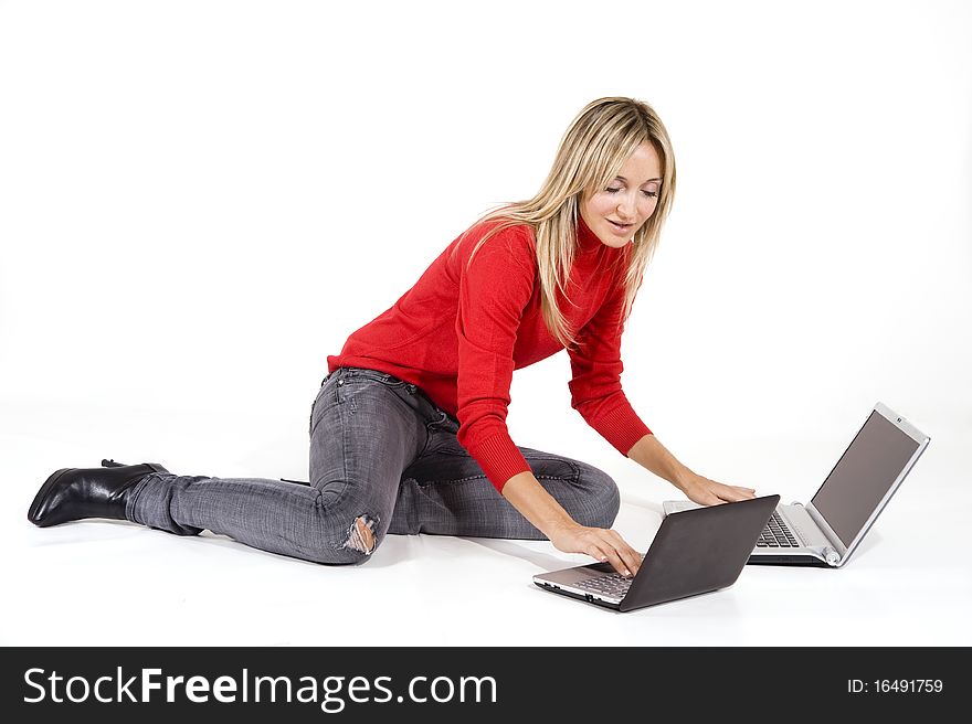 Happy working woman lying on the floor with her laptop