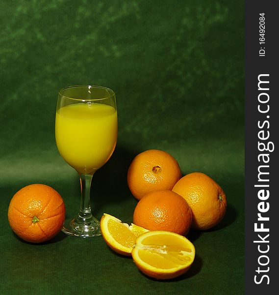 Display of oranges with a glass of fresh squeezed orange juice. Display of oranges with a glass of fresh squeezed orange juice