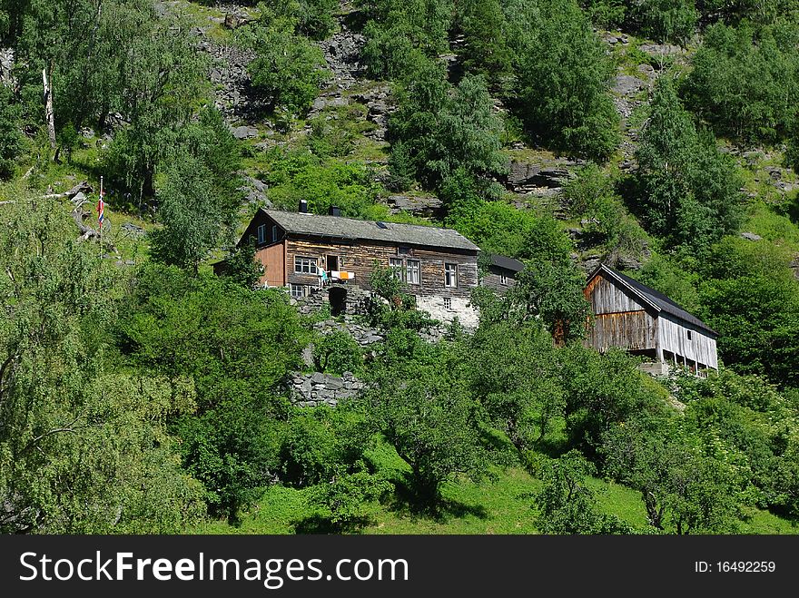 Traditional wooden houses on hillside near Geiranger, Norway. Traditional wooden houses on hillside near Geiranger, Norway