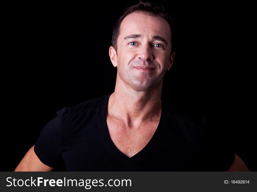 Portrait of a handsome man, isolated on black background. Studio shot. Portrait of a handsome man, isolated on black background. Studio shot.