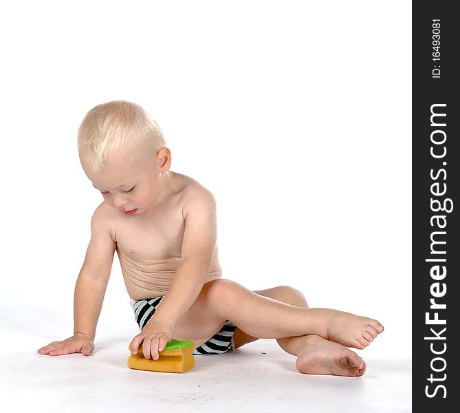 Beautiful baby with a sponge, isolated on white background