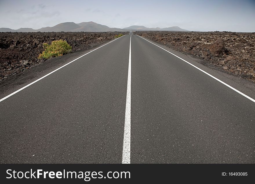 Road between volcanic rocks, Lanzarote. Road between volcanic rocks, Lanzarote