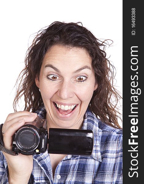 A woman has a video camera and is watching it looking excited. A woman has a video camera and is watching it looking excited.