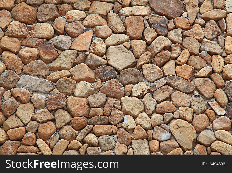 Traditional Stone Brick Wall made of fragment stones in irregular shapes. Traditional Stone Brick Wall made of fragment stones in irregular shapes