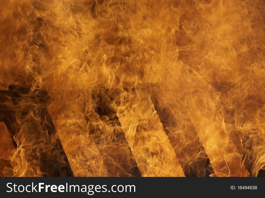 Intense flames burning a wooden structure. Intense flames burning a wooden structure.
