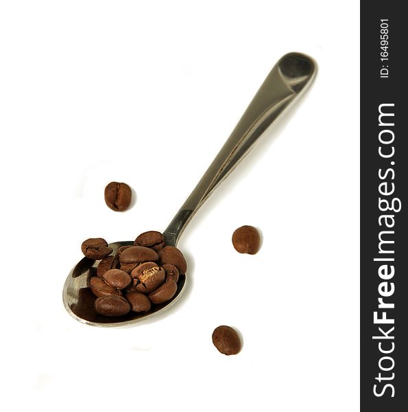 Spoon with coffee grains on a white background