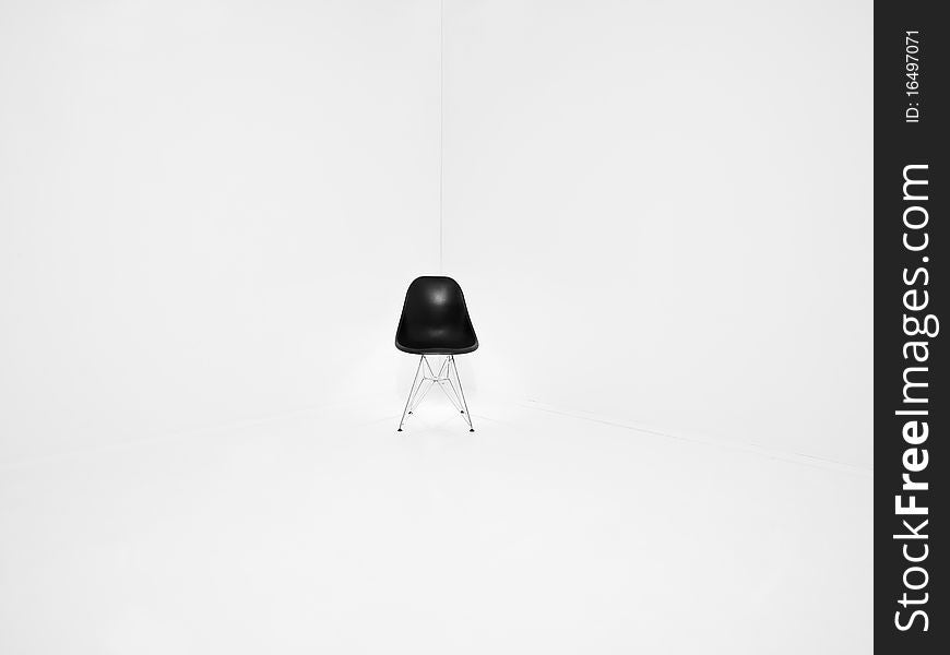 Retro chair in a corner of a white room