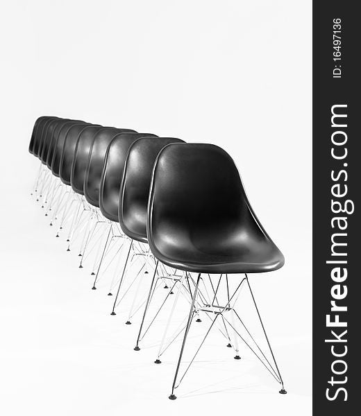 Black chairs in a row isolated on white background