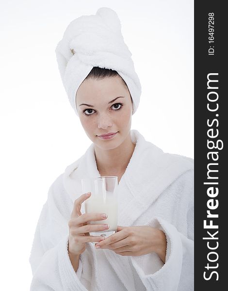 Beauty in bathrobe with glass of milk