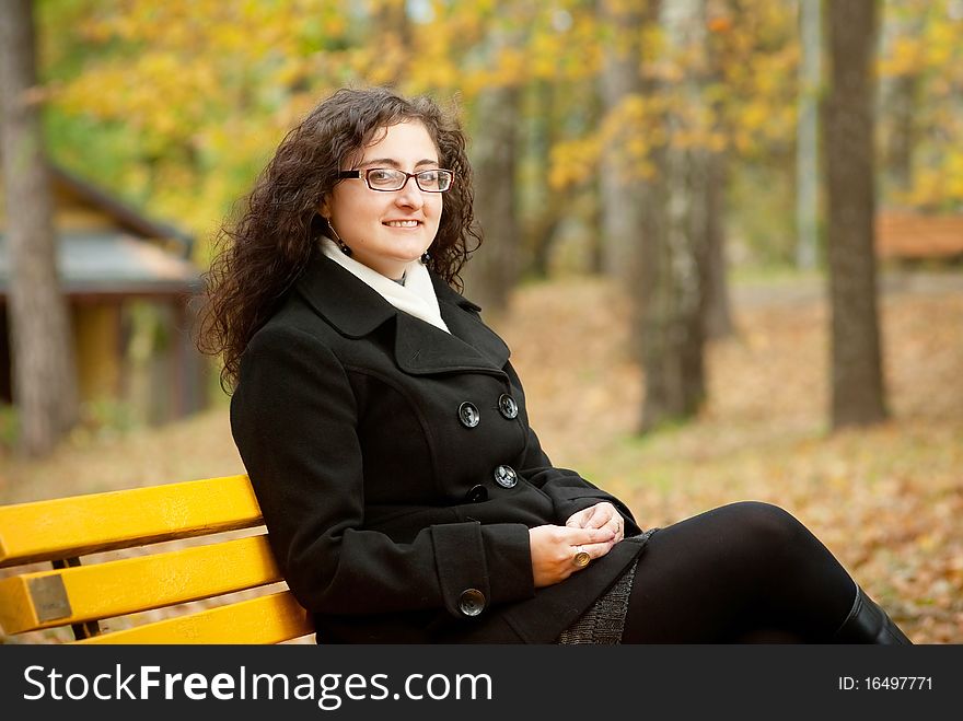 Smilling woman sitting on bench