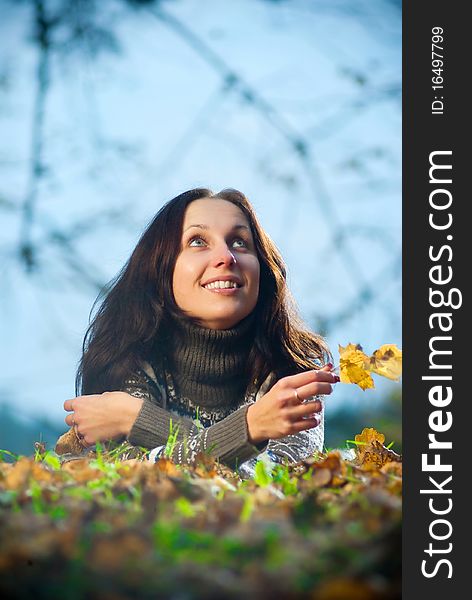 Young woman dream in autumn park with evening light