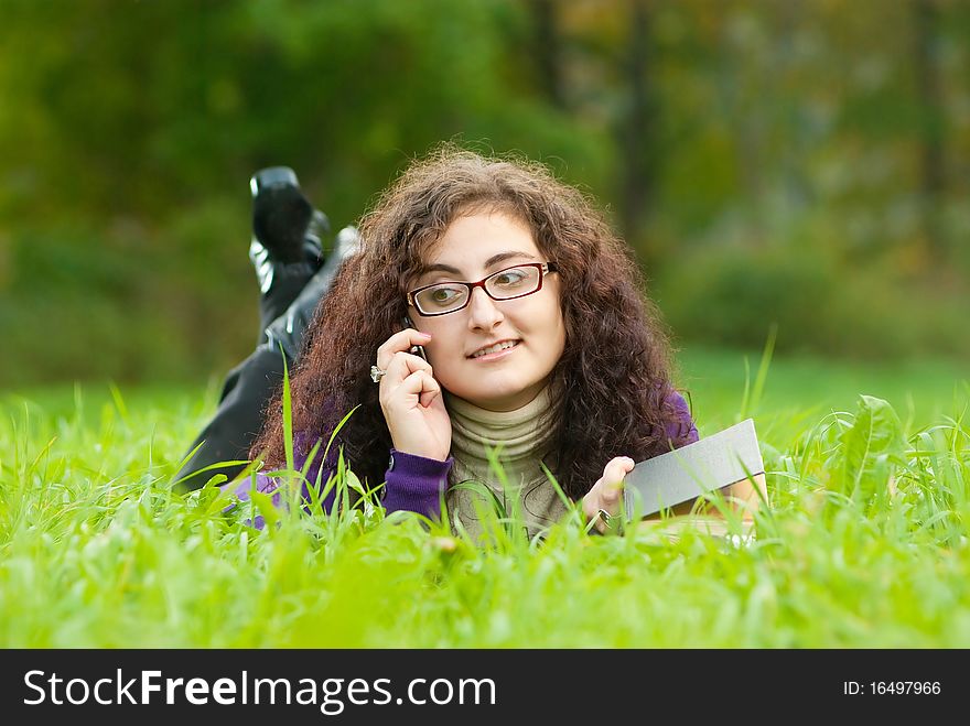 Young woman lays on a grass