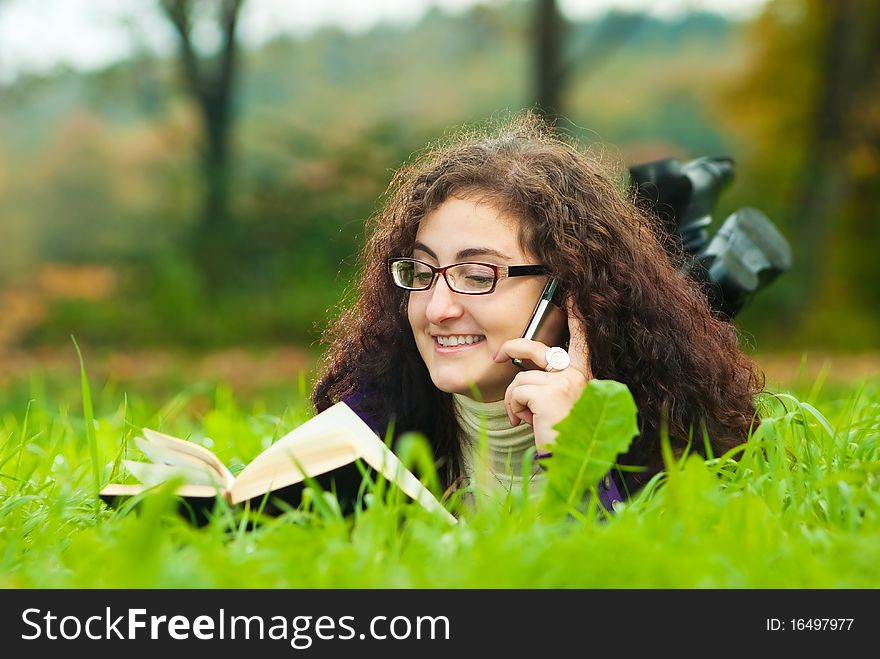 Young woman lays on a grass