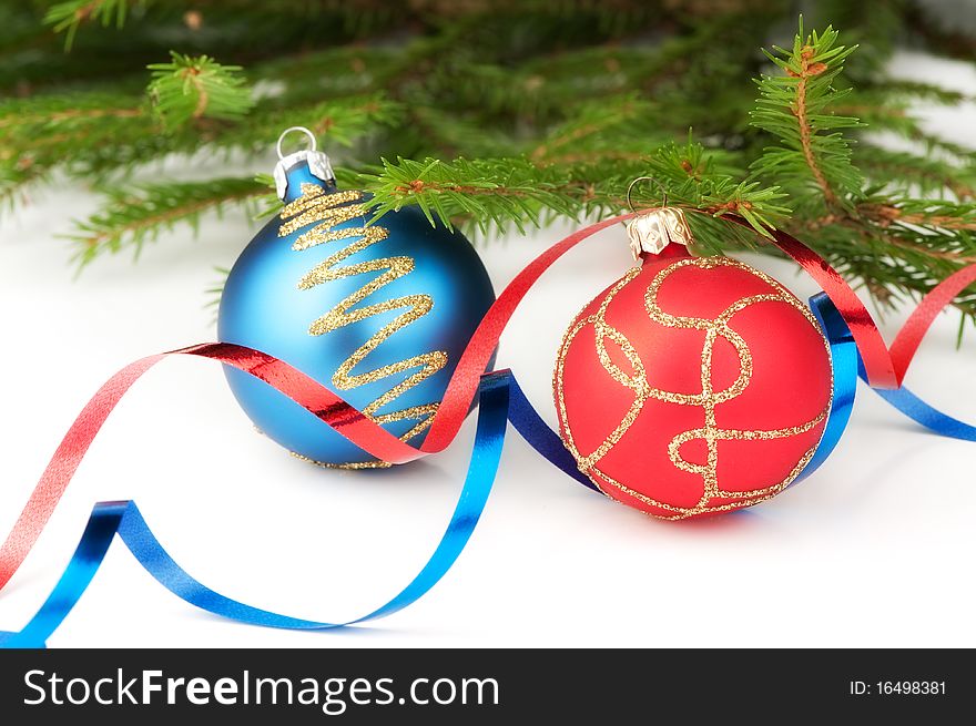 Christmas baubles with curly ribbon and christmas tree on a white background. Christmas baubles with curly ribbon and christmas tree on a white background