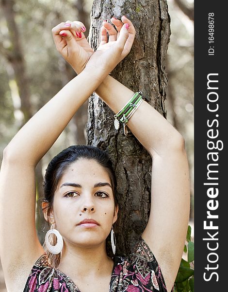 Beautiful girl with floral dress posing on a forest. Beautiful girl with floral dress posing on a forest.