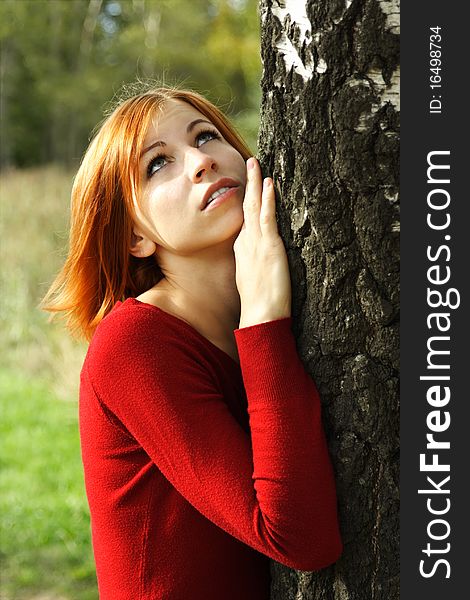 Girl In Red Dress Snuggle Up To Tree