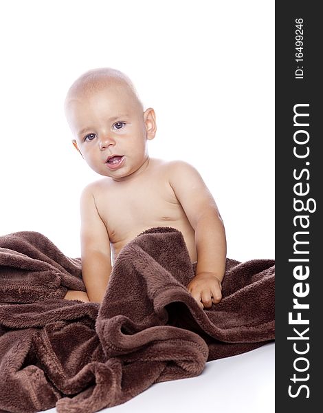 A beautiful baby with brown towel on white