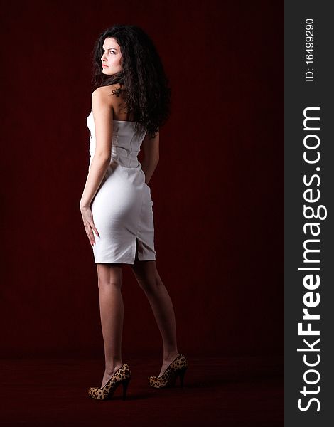 Fashion model wearing white dress and high heel shoes. Fashion model wearing white dress and high heel shoes