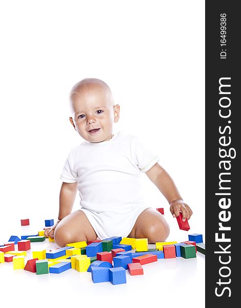 The kid plays with cubes on a white background