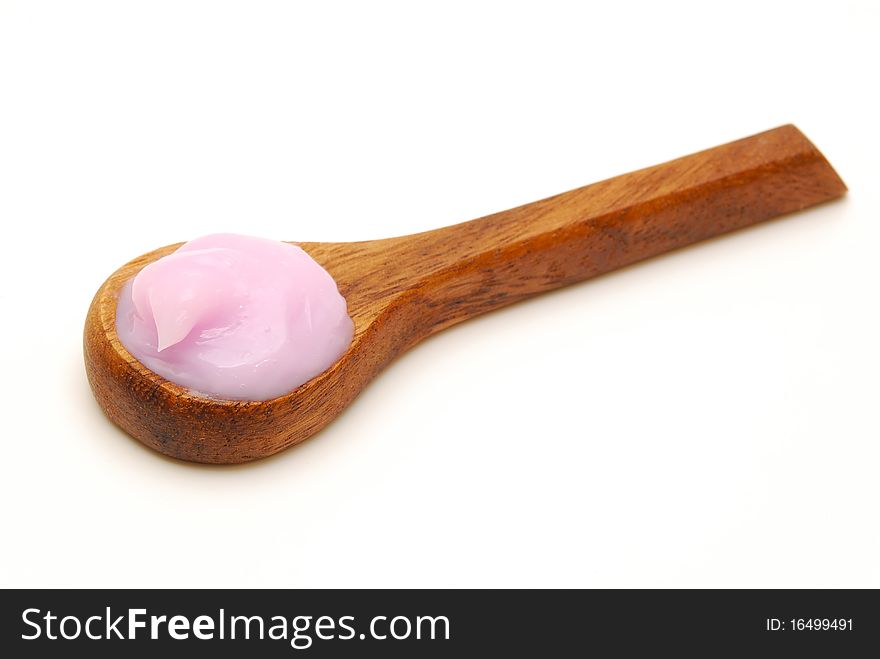 Pink body cream on wooden spoon isolated. Pink body cream on wooden spoon isolated