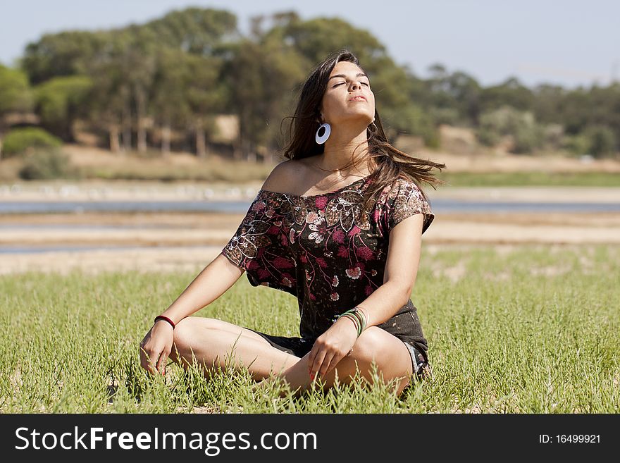 Beautiful girl with floral dress meditating on the nature. Beautiful girl with floral dress meditating on the nature.