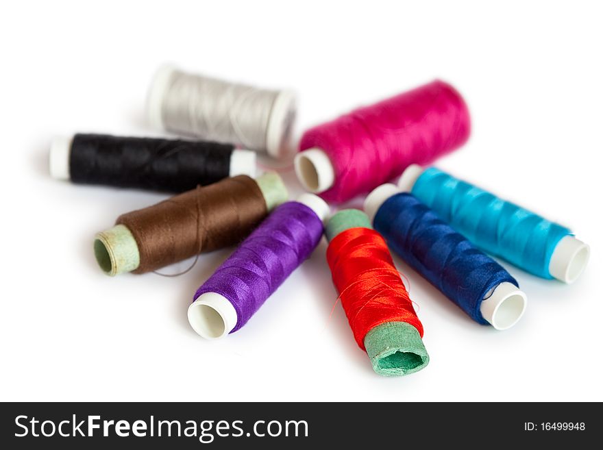 Coils of colour threads isolated on white background