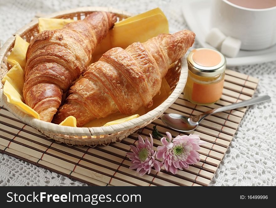 Breakfast with two croissants, honey and coffee. Breakfast with two croissants, honey and coffee