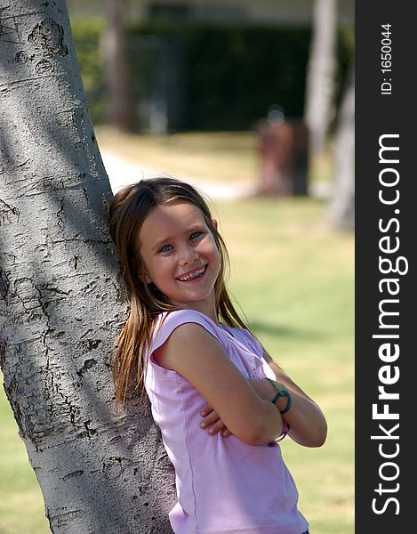 Girl Leaning on Tree