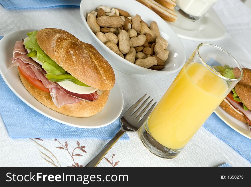 Breakfast with sandwich and orange juice close up