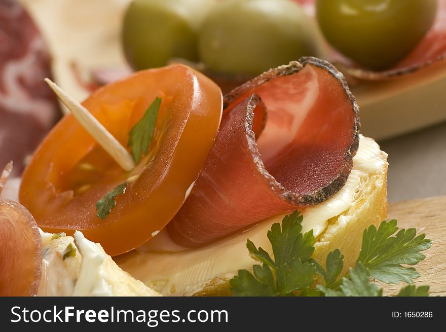 Mini prosciutto sandwich with tomato close up