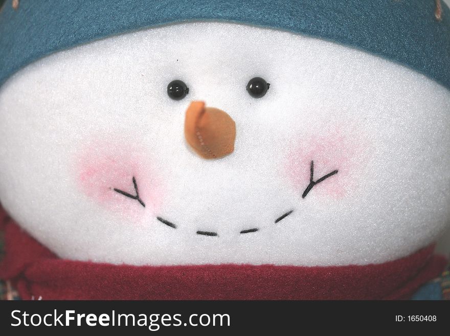 A close up of a happy smiling snowmans face