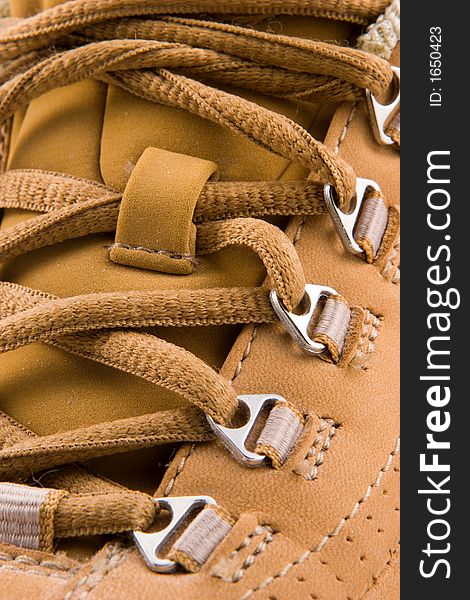 Close up view of a soft leather walking shoe, showing laces in detail.